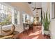 Bright sunroom with terracotta flooring, ample windows, and comfortable seating at 216 Florida Ave, New Smyrna Beach, FL 32169