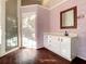 Bathroom with white vanity, wood floor, and glass shower at 216 Ocean Dr, New Smyrna Beach, FL 32169