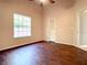 Bright bedroom with wood floors and a large window at 216 Ocean Dr, New Smyrna Beach, FL 32169