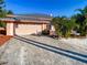 Single-story home with a large driveway and mature landscaping at 216 Ocean Dr, New Smyrna Beach, FL 32169