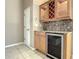 Built-in wet bar with wine rack and beverage cooler at 216 Ocean Dr, New Smyrna Beach, FL 32169