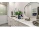 Modern bathroom featuring dual vanities, round mirrors, and a glass shower at 2866 Isles Way, New Smyrna Beach, FL 32168