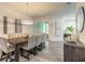 Dining area with large table, contemporary light fixture, and sliding door access to patio at 2866 Isles Way, New Smyrna Beach, FL 32168