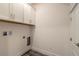 Bright laundry room with white cabinets, hookups, and ample space at 2866 Isles Way, New Smyrna Beach, FL 32168