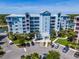 Aerial view of a waterfront condo building with parking and boat slips at 3 Riverwalk Dr # 303, New Smyrna Beach, FL 32169