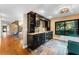 Modern wet bar with granite countertops, wine storage, and a built-in beverage cooler at 311 Partridge Ln, Longwood, FL 32779