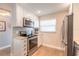 Modern kitchen with stainless steel appliances and white cabinets at 315 N Causeway # B301, New Smyrna Beach, FL 32169