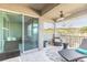 Covered balcony with outdoor furniture, ceiling fan, and view of the surrounding area at 3414 Medici Blvd, New Smyrna Beach, FL 32168