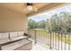 Relaxing balcony with outdoor furniture and scenic views of the surrounding trees and greenery at 3414 Medici Blvd, New Smyrna Beach, FL 32168