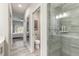 Bathroom with glass shower, toilet, and sliding barn door opening to the bedroom at 3414 Medici Blvd, New Smyrna Beach, FL 32168