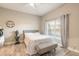 Bedroom with gray bed, wood-look flooring, white walls, and a large window at 3414 Medici Blvd, New Smyrna Beach, FL 32168