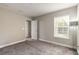 Empty bedroom with carpet, neutral gray walls, and two windows at 3414 Medici Blvd, New Smyrna Beach, FL 32168