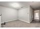 Empty bedroom with gray carpet, white walls, and a door leading to another room at 3414 Medici Blvd, New Smyrna Beach, FL 32168