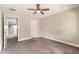 Bedroom with gray carpet, open door, and a view of the loft at 3414 Medici Blvd, New Smyrna Beach, FL 32168