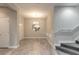 Dining area with a circular mirror, chandelier, and carpeted staircase at 3414 Medici Blvd, New Smyrna Beach, FL 32168