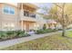 Inviting two-story townhome with a covered balcony, front yard landscaping, and a paved walkway at 3414 Medici Blvd, New Smyrna Beach, FL 32168