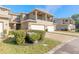 Exterior view of townhome with attached garage, balcony, and lush landscaping at 3414 Medici Blvd, New Smyrna Beach, FL 32168