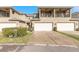 Front exterior of townhome with two-car garage, balcony, and landscaped yard at 3414 Medici Blvd, New Smyrna Beach, FL 32168