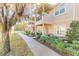 Townhome exterior with a covered entryway, landscaping, and a sidewalk at 3414 Medici Blvd, New Smyrna Beach, FL 32168