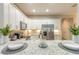 Bright kitchen featuring white shaker cabinets, stainless steel appliances, and granite countertops at 3414 Medici Blvd, New Smyrna Beach, FL 32168