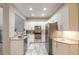 Well-appointed kitchen with modern appliances, white cabinetry, and a view of the staircase at 3414 Medici Blvd, New Smyrna Beach, FL 32168