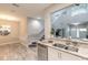 View of the kitchen and staircase from the dining area, showing stainless steel appliances and granite countertop at 3414 Medici Blvd, New Smyrna Beach, FL 32168