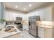 White kitchen with stainless steel appliances, granite countertops, and ample cabinet space at 3414 Medici Blvd, New Smyrna Beach, FL 32168