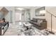 Living room with stylish furniture, a large area rug, and an entryway view at 3414 Medici Blvd, New Smyrna Beach, FL 32168