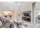 Open-concept living room with high ceilings, modern decor, and a view of the kitchen at 3414 Medici Blvd, New Smyrna Beach, FL 32168