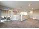 Open loft area with sliding glass doors to a balcony, carpeted floors, and neutral walls at 3414 Medici Blvd, New Smyrna Beach, FL 32168
