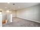 Large, carpeted loft space with white walls and a staircase at 3414 Medici Blvd, New Smyrna Beach, FL 32168