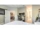 Main bedroom with a workspace, ensuite bathroom, and a view into a living area at 3414 Medici Blvd, New Smyrna Beach, FL 32168