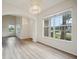 Bright dining room with LVP flooring and large windows at 346 N Airport Rd, New Smyrna Beach, FL 32168