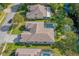 An aerial view of a house with a screened-in pool and a backyard adjacent to a canal at 3769 Fiano Dr, Port Orange, FL 32129