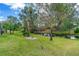 Spacious backyard with lush green grass and a tranquil pond view at 3769 Fiano Dr, Port Orange, FL 32129