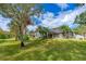 Expansive backyard featuring a screened-in patio, landscaping, and a pond at 3769 Fiano Dr, Port Orange, FL 32129