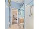 Bathroom featuring light blue walls, a single vanity, and a doorway to an adjacent room at 3769 Fiano Dr, Port Orange, FL 32129