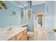 Bathroom with light blue walls, a single vanity, and a door leading to the pool area at 3769 Fiano Dr, Port Orange, FL 32129