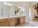 Double vanity bathroom with light wood cabinets and tile flooring at 3769 Fiano Dr, Port Orange, FL 32129