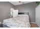 Bedroom with a queen-sized bed, gray walls, and a floral patterned comforter at 3769 Fiano Dr, Port Orange, FL 32129