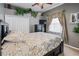 Bedroom with dark wood furniture, patterned bedding, and large window with curtains at 3769 Fiano Dr, Port Orange, FL 32129
