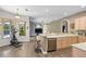 Open-concept kitchen and living area with a breakfast bar, modern appliances, and views of the pool at 3769 Fiano Dr, Port Orange, FL 32129