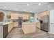 Spacious kitchen featuring ample light wood cabinets, a center island, and stainless steel appliances at 3769 Fiano Dr, Port Orange, FL 32129