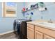 Laundry room equipped with a washer, dryer, sink, and overhead storage at 3769 Fiano Dr, Port Orange, FL 32129