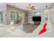 Open living room with pool view, white sectional, and built-in entertainment center at 3769 Fiano Dr, Port Orange, FL 32129