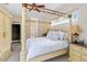 Main bedroom featuring four-poster bed, ensuite bathroom access, and carpeted floors at 3769 Fiano Dr, Port Orange, FL 32129