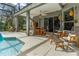 Screened lanai with a refreshing pool, comfortable seating, and lush landscaping at 3769 Fiano Dr, Port Orange, FL 32129