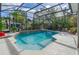 Inviting pool area enclosed by a screen cage and surrounded by lush landscaping at 3769 Fiano Dr, Port Orange, FL 32129