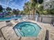 Community hot tub with surrounding lounge chairs at 4208 Sun Village Ct # 4208, New Smyrna Beach, FL 32169