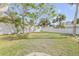 Fenced backyard with grass and trees at 4211 S Peninsula Dr, Port Orange, FL 32127